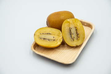 Kiwi fruit in a wooden bowl on white background