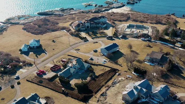 House demolition aerial view with machines at work on ocean coast