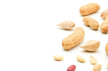 Fototapeta na wymiar Peanuts and almonds lie next to fried kernels of peanuts on a white background.