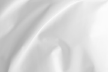 Abstract white fabric texture background. Cloth soft wave. Creases of satin, silk, and cotton.