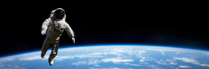 astronaut performing a spacewalk in empty space 