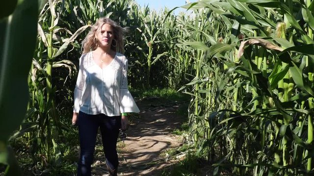 Beautiful Woman Walking Through A Corn Maze