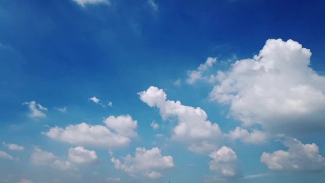 White puffy clouds and blue sky time-lapse with long second duration for background and graphics in daylight. 4K 30fps