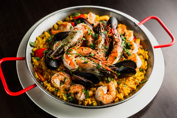 Authentic spanish seafood paella in a frying pan