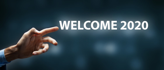 man clicks on the screen. welcome 2020