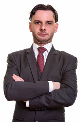 Close up of young businessman with arms crossed