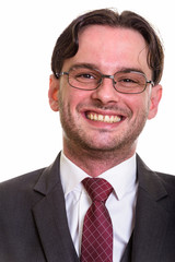 Face of young happy businessman smiling while wearing eyeglasses