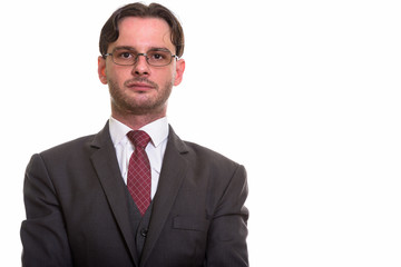 Studio shot of young businessman in suit wearing eyeglasses