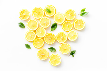 Lemon slices and leaves on white background top view copy space