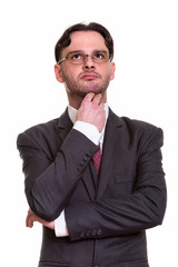 Close up of young businessman thinking while looking up