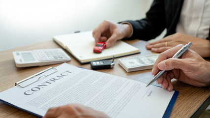 agent broker man holding document showing an transportation contract form to client ownership  customer and salesman with car key.