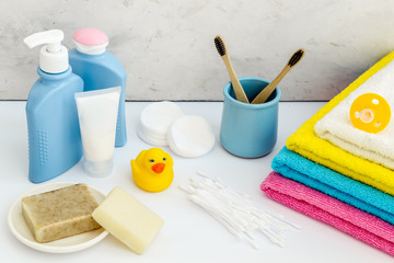 Baby bathroom cosmetics near pacifier and rubber duck on white background