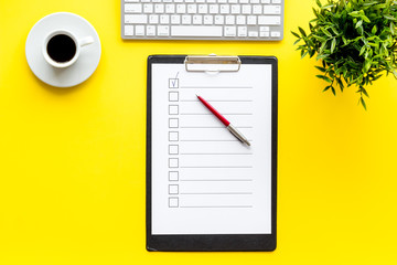 Empty check list ready to fill on yellow background top view