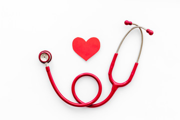 Health care concept. Heart icon and stethoscope on white background top view