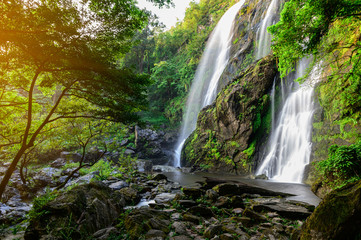 Fototapeta na wymiar A beautiful waterfall deep in the tropical forest steep mountain adventure in the rainforest.