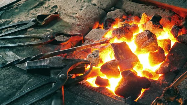 Blacksmithing tools near fire. 4K footage