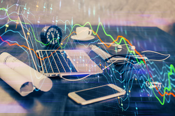 Financial market graph hologram and personal computer on background. Double exposure. Concept of forex.