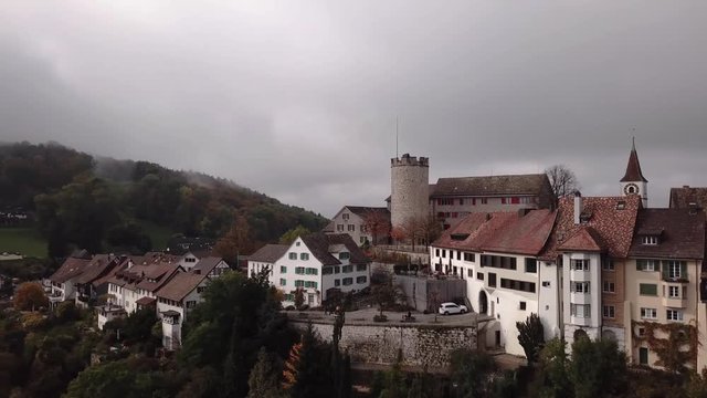 Aerial over the hilltop town of Regensberg in Zurich, Switzerland. Drone slow backward dolly