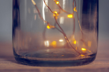 Lights garland in a glass bottle on a dark background