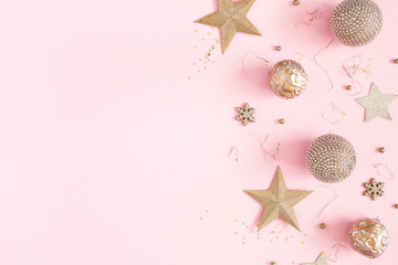 Christmas composition. Golden decorations on pastel pink background. Christmas, winter, new year concept. Flat lay, top view, copy space