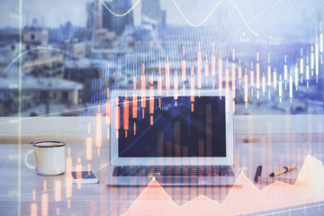 Financial chart drawing and table with computer on background. Double exposure. Concept of...