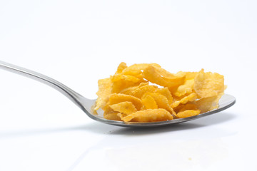 Cornflakes on spoon  isolated on white background