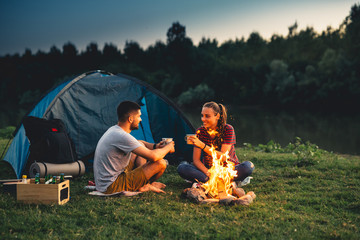 romantic couple on camping by the river outdoors