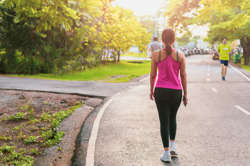 Attractive women exercise walking in the park.
