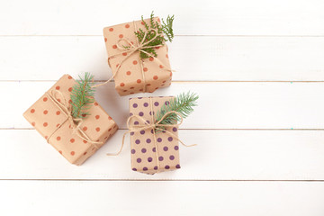 Tied bows gift boxes on white wooden background, top view