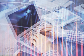 Double exposure of forex chart with man working on computer on background. Concept of market analysis.