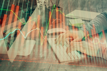 Double exposure of financial graph with man works in office on background. Concept of analysis.