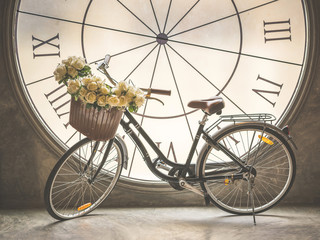Fototapeta na wymiar Bouquet of rose and bicycle with clock background