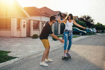 friends outdoor having fun driving skateboard