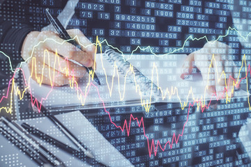 Forex chart hologram on hand taking notes background. Concept of analysis. Multi exposure