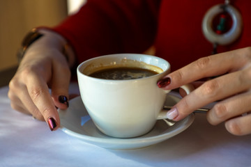 woman holding a cup of coffee in her hands