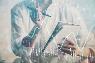 Financial chart drawn over hands taking notes background. Concept of research. Multi exposure