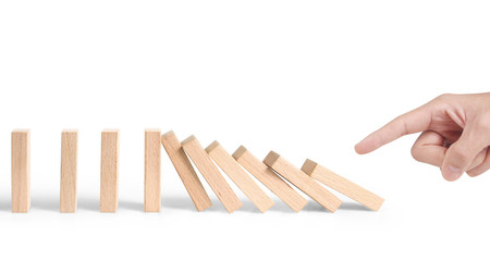 Hand stopping the Domino effect stopped by unique