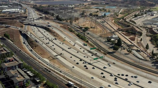 Daytime freeway traffic through wildfires, Los Angeles, aerial view