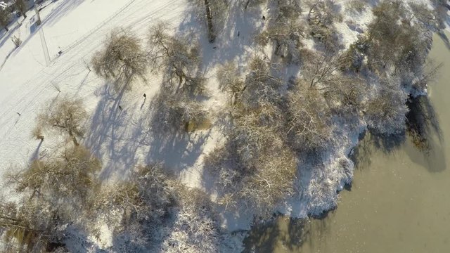 Snowy Urban Lake on a Sunny Day Aerial Footage looking strait down (Shot 3 of 3)