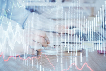 Multi exposure of financial graph with man works in office on background. Concept of analysis.