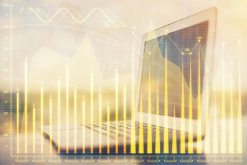 Stock market chart hologram drawn on personal computer background. Double exposure. Concept of investment.