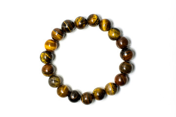 Close up of lucky stone bracelet made from tiger's eyes stone isolated on white background.
