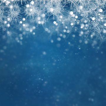 Christmas blue sophisticated blurry and clear falling snowflakes background in red colors with bokeh effect.