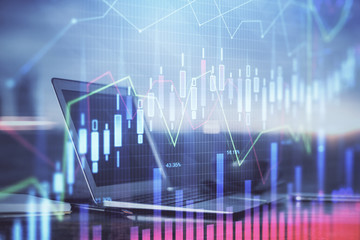Stock market chart hologram drawn on personal computer background. Double exposure. Concept of investment.