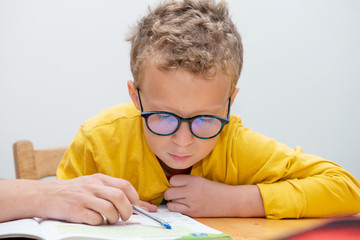 Naklejka na ściany i meble little boy doing his homework