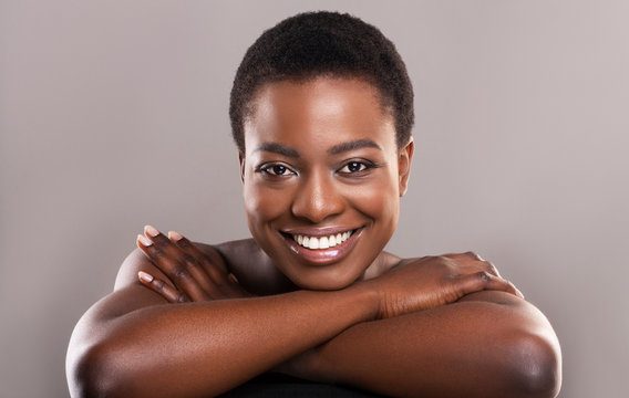 Beautiful nude black woman with flawless skin and charming smile