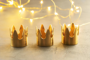 Three gold crowns, symbol of Tres Reyes Magos  ( Three Wise Men) who come bringing gifts for the kids on Epiphany or Dia de Reyes Magos. - obrazy, fototapety, plakaty