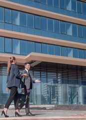 young employees are on a city street.