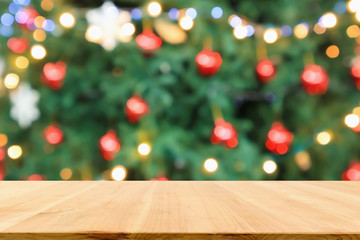 Empty wood table top with Abstract blur Christmas tree with decoration bokeh light background for product display