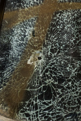 Broken car after an accident. Broken car glass. Broken windshield of car after collision. Robbers...